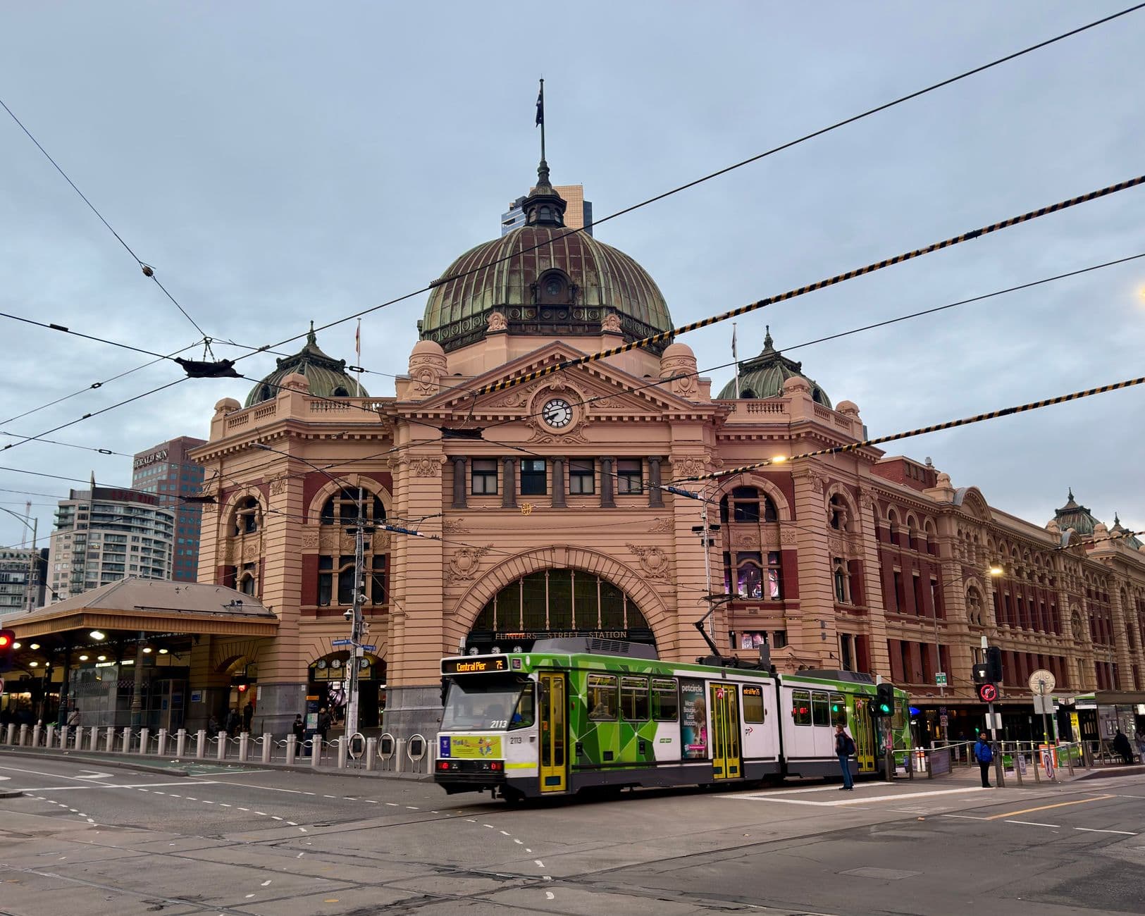 Iconic Flinders Street Station and tram captured during the day in Melbourne, Australia.